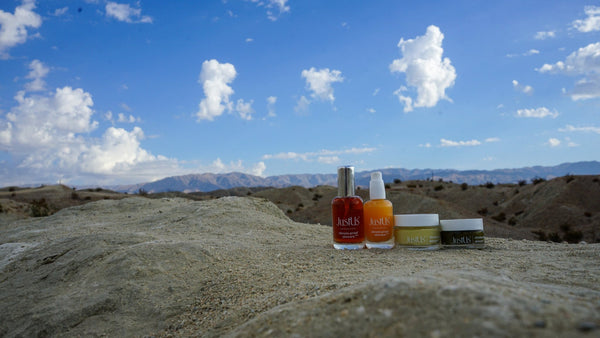 Fab Four Products on Mountain edge with sky and mountain rang in the background.